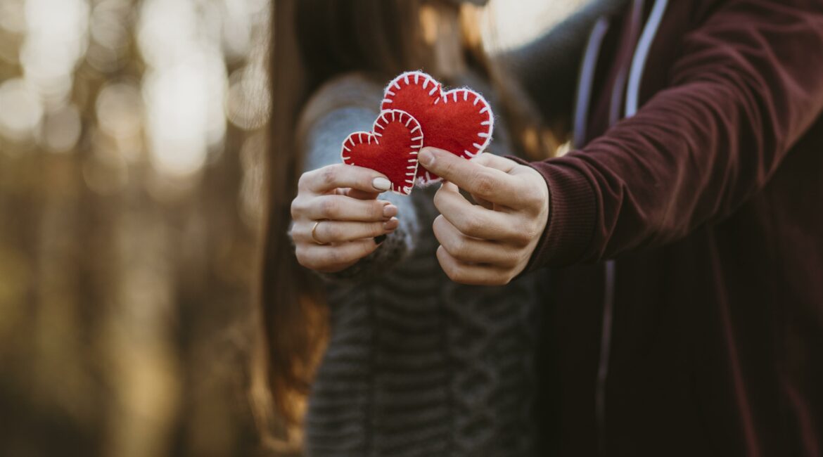 close up couple holding little hearts